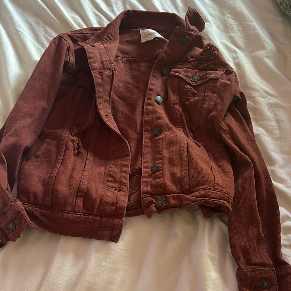 Rusty amber colored jean jacket. Adult small.